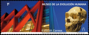 Museum of Human Evolution in Burgos and skull of Homo heidelbergensis or an early Neanderthal man on stamp of Spain 2020
