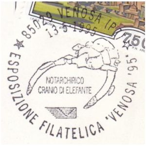 Tusks and skull of prehistoric elephant on postmark of Italy 1995